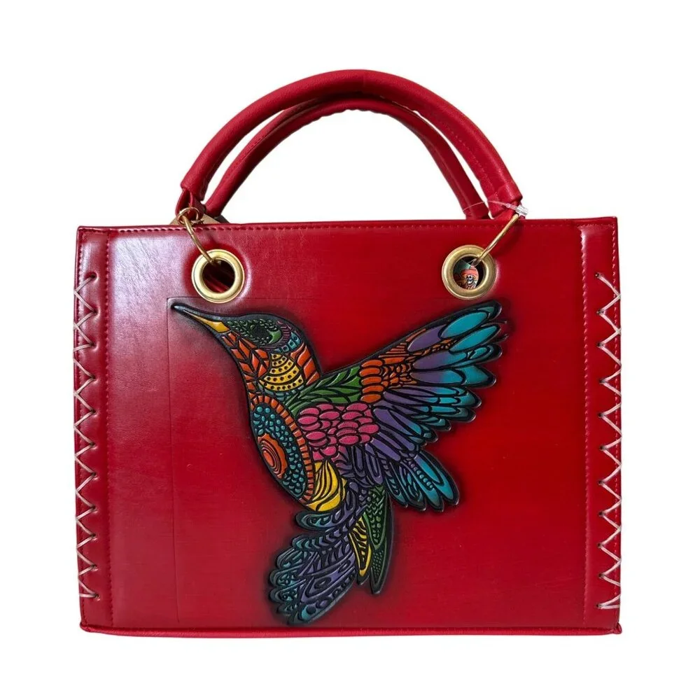Tooled multicolored hummingbird on a vegan leather red satchel with make up bag